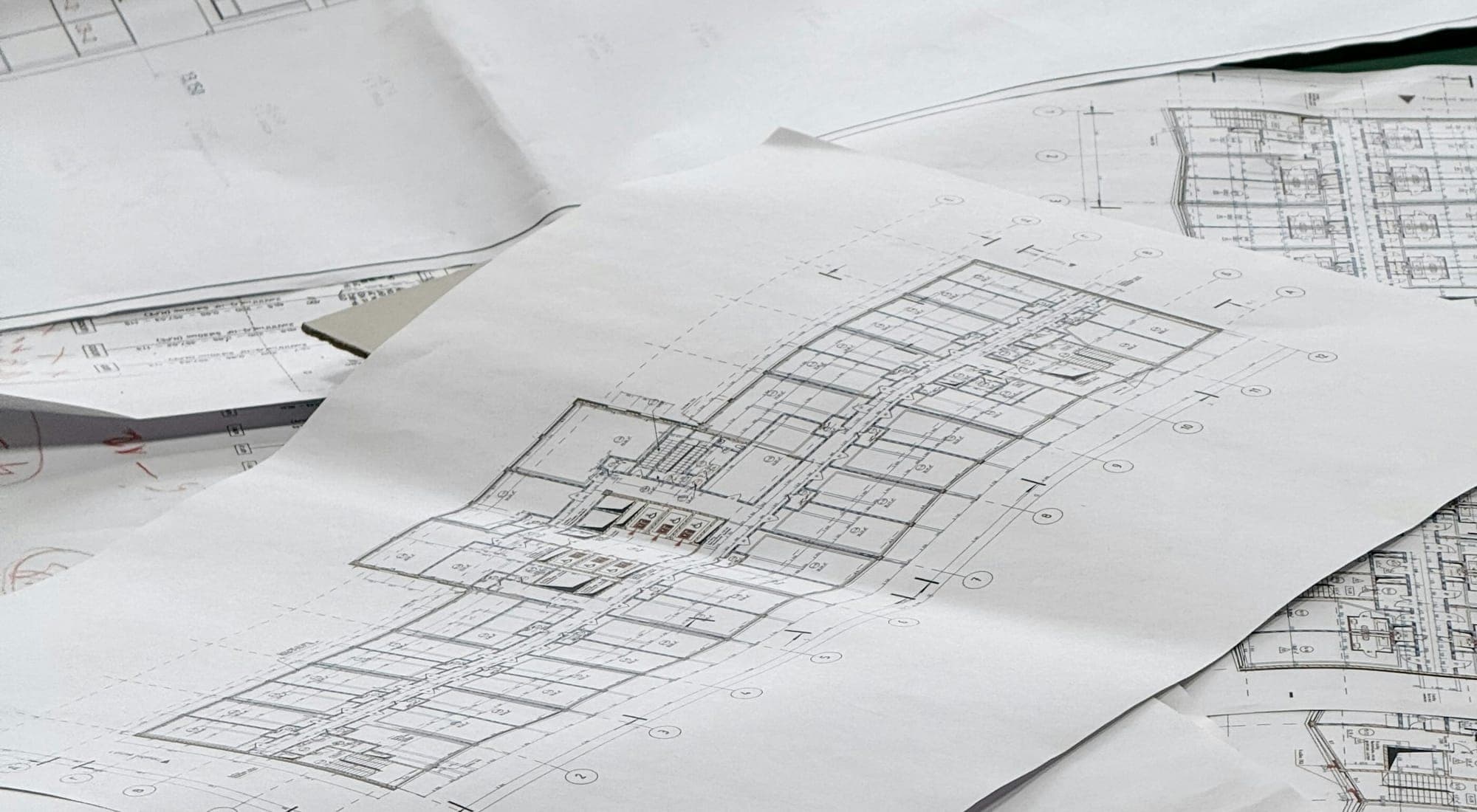 Architectural and structural drawings spread across a desk